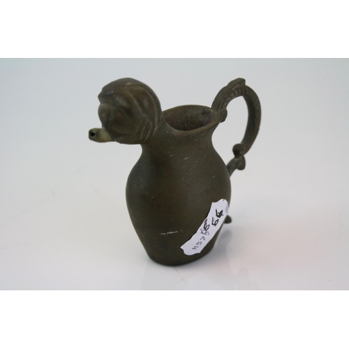 192 - A small bronze miniature drinking vessel.