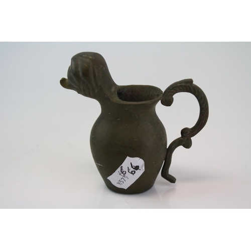 192 - A small bronze miniature drinking vessel.