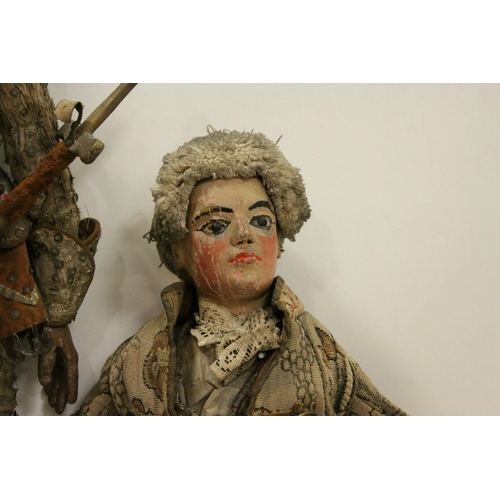 262 - Two large carved wooden dolls with painted faces in 18th century costume believed to be Continental.