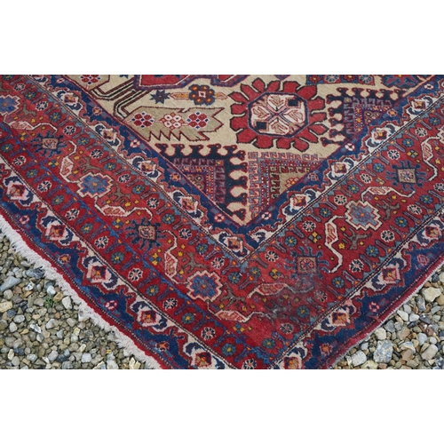 889 - Eastern Wool Red Ground Rug with stylised pattern, 330cms x 170cms