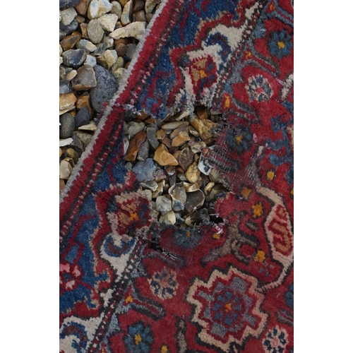 889 - Eastern Wool Red Ground Rug with stylised pattern, 330cms x 170cms