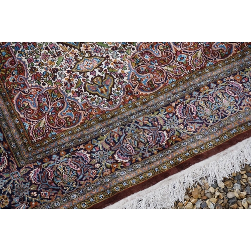 890 - Eastern style Silk Rug, the stylised pattern including foliage, 306cms x 183cms
