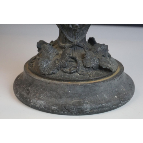 115 - A 19th century bronze two handled cup profusely decorated with grape vines mounted on a stone base p... 