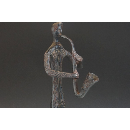 121 - Bronze stylized figure of a man playing a Saxophone, 42 cm tall.