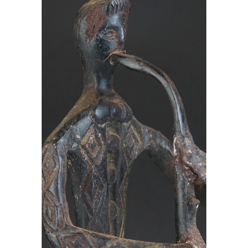 121 - Bronze stylized figure of a man playing a Saxophone, 42 cm tall.