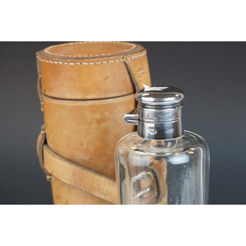 133 - A vintage leather saddle flask holder with silverplated and glass flask by James Dixon and Sons