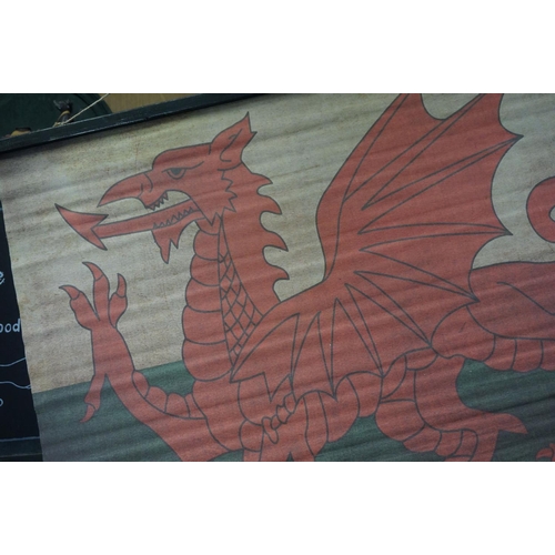 146 - Canvas Hanging Banner of Welsh Dragon Flag, supported on wooden poles, 95cms x 70cms