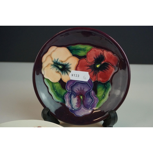 15 - Three Moorcroft Pin Dishes, two in the Hibiscus pattern on white grounds and the other in the Pansy ... 