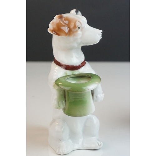 163 - A green Sylvac style dog, a ceramic terrier holding a hat and a Rushton Pottery Isle of Mann Manx ca... 
