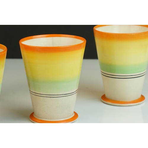 164 - Set of Four Art Deco beakers with banded decoration, in the manner of Clarice Cliff