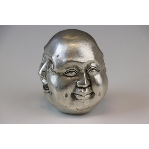 170 - A white metal paperweight in the form of a four faced Buddha signed with character marks.