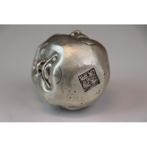 170 - A white metal paperweight in the form of a four faced Buddha signed with character marks.