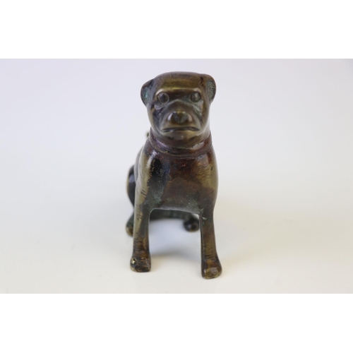 174 - A bronze figure of a seated dog.