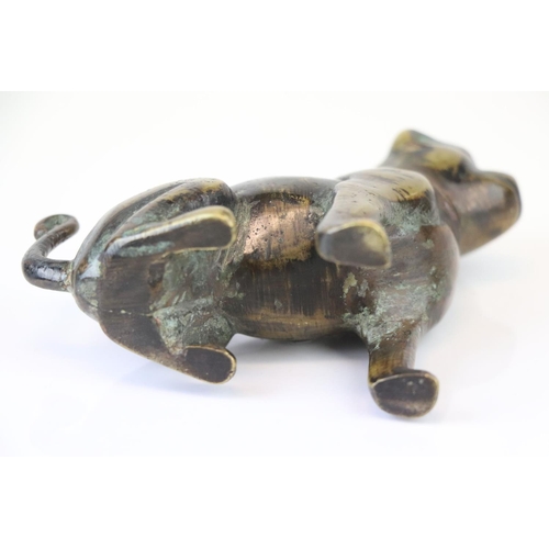 174 - A bronze figure of a seated dog.