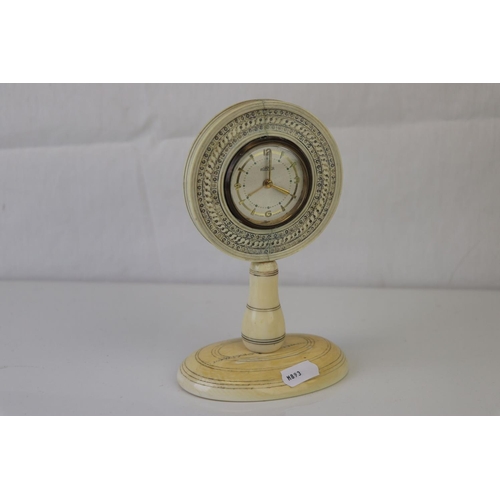 184 - A desk clock with Roamer movement mounted within ivory stand.