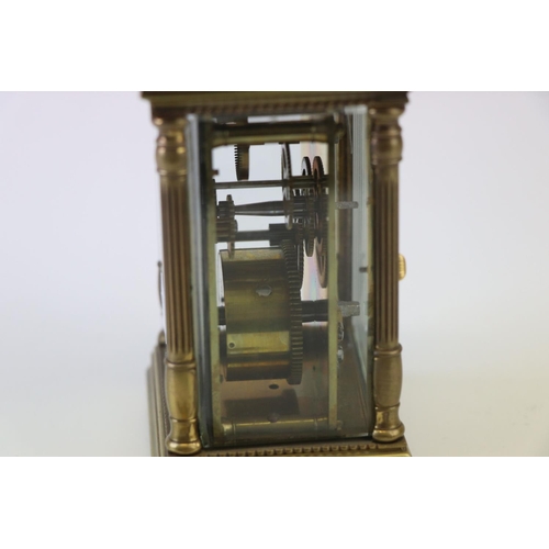 186 - A French made brass carriage clock with white enamel dial, complete with key.