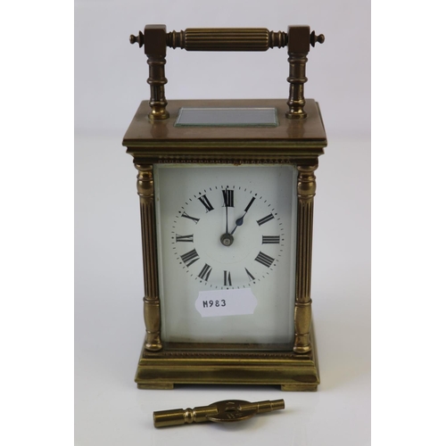 186 - A French made brass carriage clock with white enamel dial, complete with key.