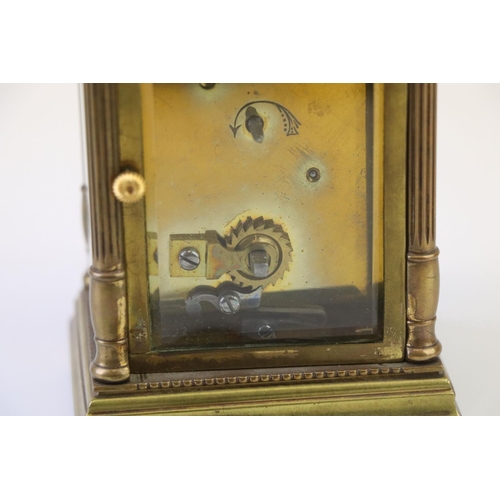 186 - A French made brass carriage clock with white enamel dial, complete with key.