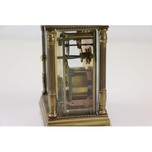 186 - A French made brass carriage clock with white enamel dial, complete with key.