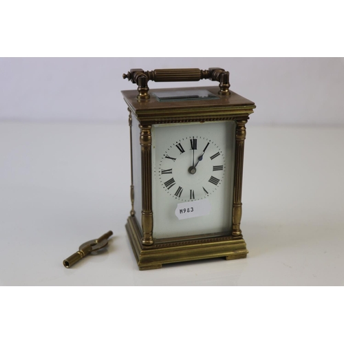 186 - A French made brass carriage clock with white enamel dial, complete with key.