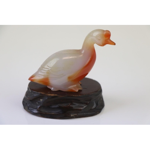 199 - A small carved jade duck on wooden base.