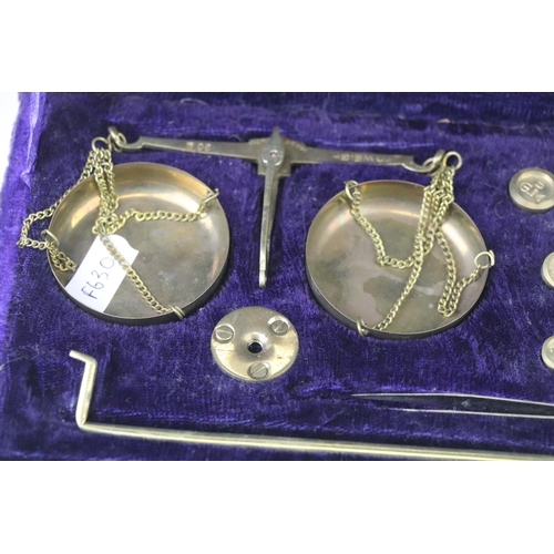212 - A set of vintage brass scales together with weights within velvet lined case.