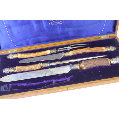 214 - A cased Mappin & Webb carving set with antler handles and hallmarked silver mounts together with a s... 