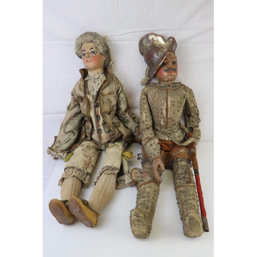 262 - Two large carved wooden dolls with painted faces in 18th century costume believed to be Continental.