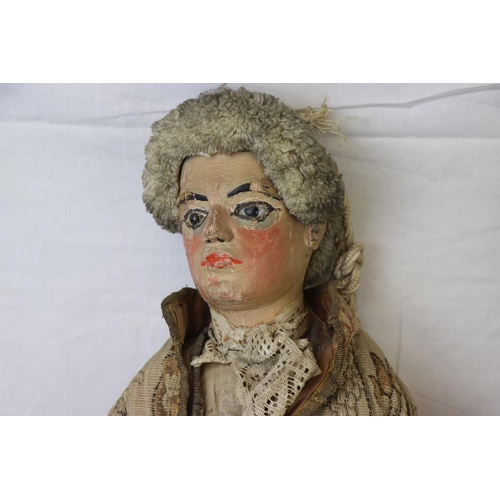 262 - Two large carved wooden dolls with painted faces in 18th century costume believed to be Continental.