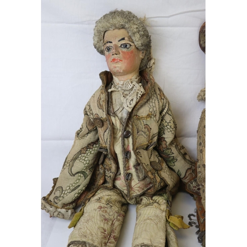 262 - Two large carved wooden dolls with painted faces in 18th century costume believed to be Continental.