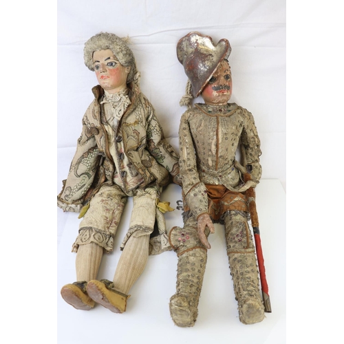 262 - Two large carved wooden dolls with painted faces in 18th century costume believed to be Continental.