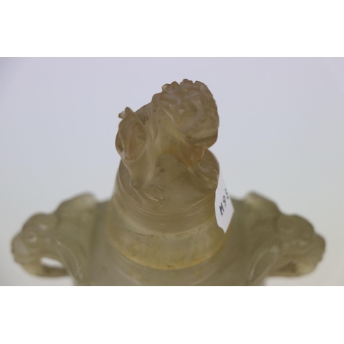 337 - An oriental carved Jadeite lidded urn with Foo dog to the lid and hardwood base.