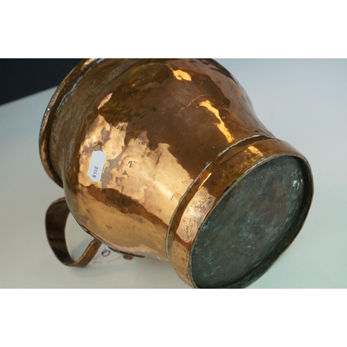 54 - Antique Copper Measuring Pot with a riveted handle, 19cms high