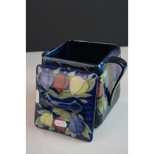 7 - Moorcroft Biscuit Barrel in the Wisteria pattern on a blue ground, restoration to lid, Moorcroft sig... 