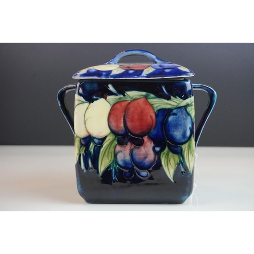 7 - Moorcroft Biscuit Barrel in the Wisteria pattern on a blue ground, restoration to lid, Moorcroft sig... 