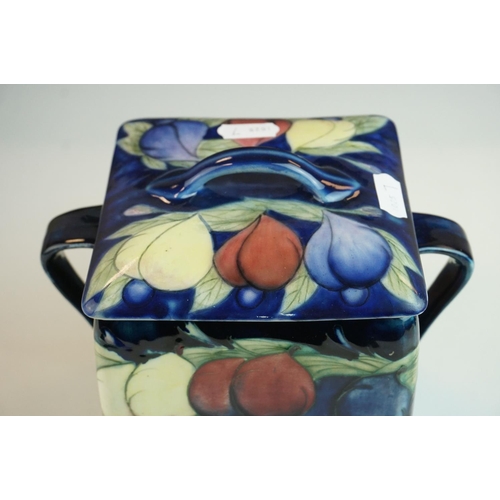 7 - Moorcroft Biscuit Barrel in the Wisteria pattern on a blue ground, restoration to lid, Moorcroft sig... 