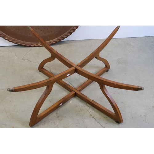 761 - Large Indian / Eastern Circular Copper Tray Top Table, raised on a hardwood folding stand with brass... 