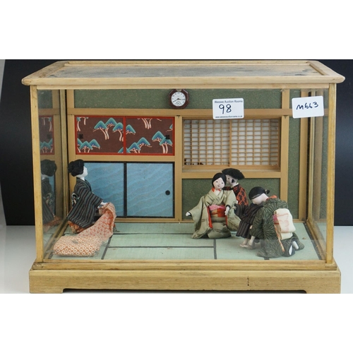 98 - A pine glazed cased of a Japanese interior with figures.in costume.