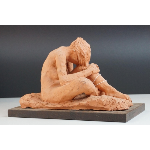 99 - A contemporary unglazed sculpture of a male figure by Ivor Plummer.