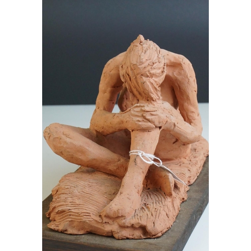 99 - A contemporary unglazed sculpture of a male figure by Ivor Plummer.