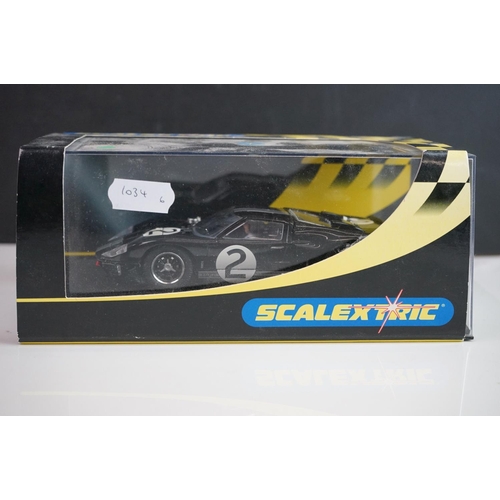 1034 - Five cased / boxed Scalextric slot cars to include C2548 Indy Car plain white, C2472 Ford GT40 plain... 