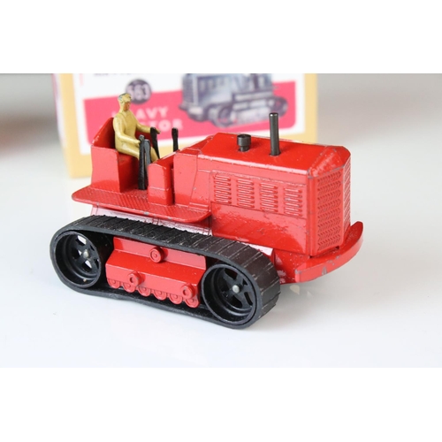 1054 - Two Dinky Supertoys 563 Heavy Tractor diecast models, variants in red & blue, both showing paint los... 