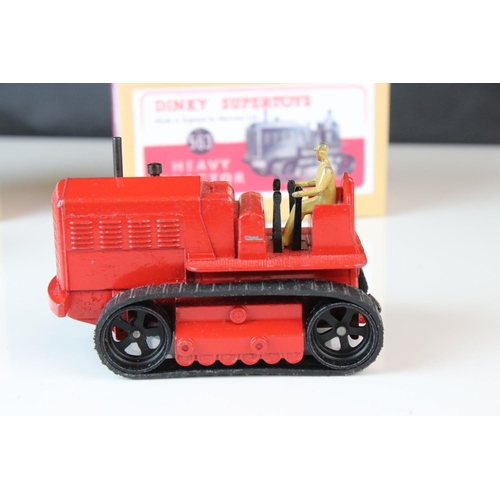 1054 - Two Dinky Supertoys 563 Heavy Tractor diecast models, variants in red & blue, both showing paint los... 