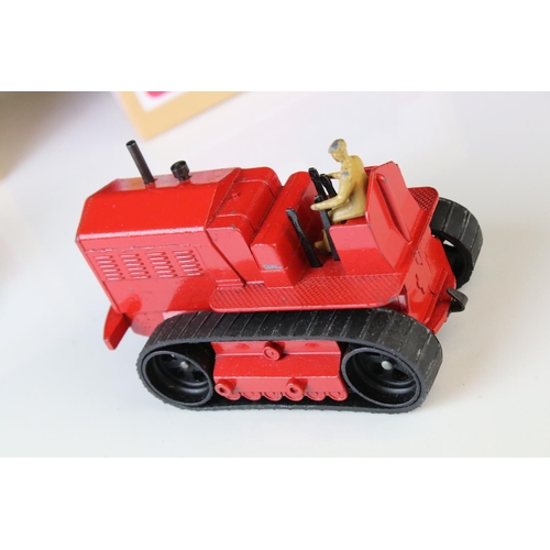 1054 - Two Dinky Supertoys 563 Heavy Tractor diecast models, variants in red & blue, both showing paint los... 