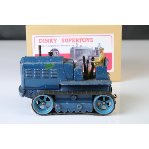 1054 - Two Dinky Supertoys 563 Heavy Tractor diecast models, variants in red & blue, both showing paint los... 