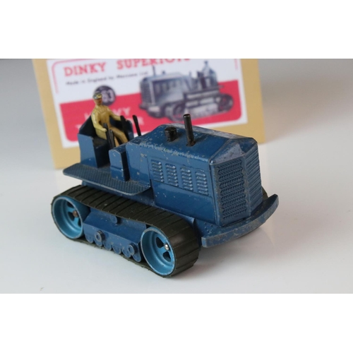 1054 - Two Dinky Supertoys 563 Heavy Tractor diecast models, variants in red & blue, both showing paint los... 