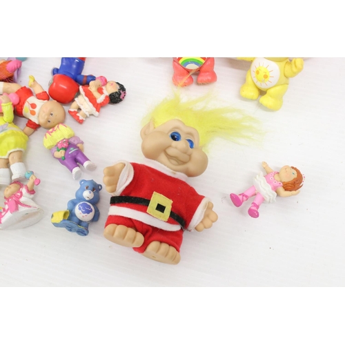 460 - Collection of Circa 80's soft toys and figurines to include Care Bears, Troll Dolls, Ed the Duck and... 