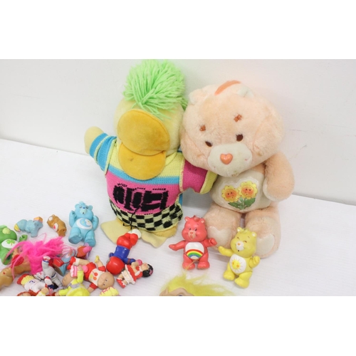 460 - Collection of Circa 80's soft toys and figurines to include Care Bears, Troll Dolls, Ed the Duck and... 