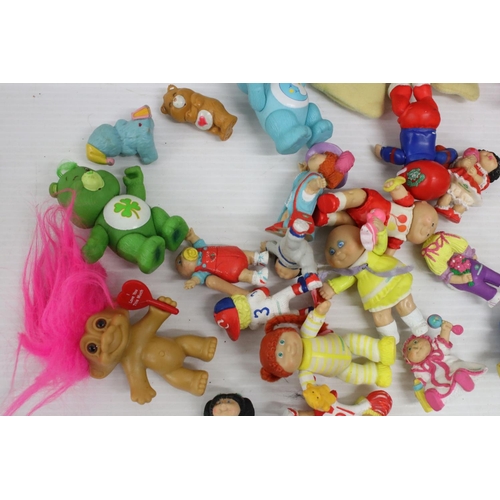 460 - Collection of Circa 80's soft toys and figurines to include Care Bears, Troll Dolls, Ed the Duck and... 