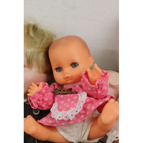 556 - Quantity of various plastic contemporary baby dolls to include a Zapf Creation Nana doll with tag (t... 